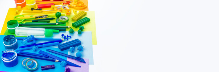 School accessories are laid out in the form of a rainbow. Copy space. white background. banner