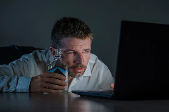 depressed alcohol addict businessman drinking bottle working drunk late  night at office laptop computer desk intoxicated suffering depression and  alcoholism problem Stock Photo | Adobe Stock