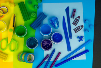 School accessories are laid out in the form of a rainbow. Black background.