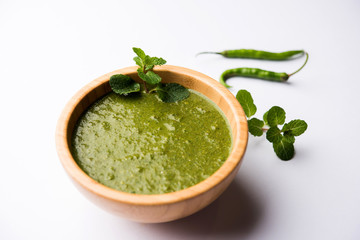 Healthy Green Mint Chutney Made with Coriander, pudina And Spices. isolated moody background. selective focus