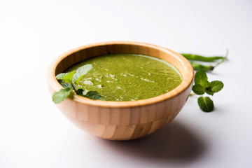 Healthy Green Mint Chutney Made with Coriander, pudina And Spices. isolated moody background. selective focus