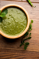Healthy Green Mint Chutney Made with Coriander, pudina And Spices. isolated moody background. selective focus