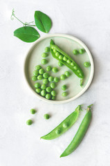 Isolated sweet green peas. Top view. Vertical photo. 