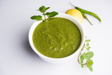 Healthy Green Mint Chutney Made with Coriander, pudina And Spices. isolated moody background. selective focus