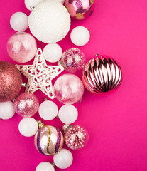 Gentle pink and white baubles on a pink background. Christmas mood. Copy space