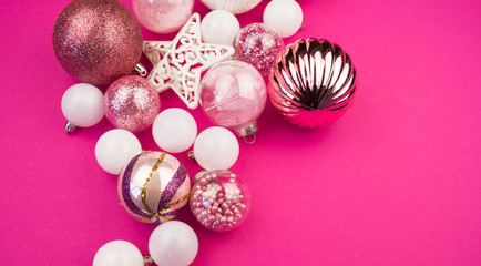 Gentle pink and white baubles on a pink background. Christmas mood. Copy space