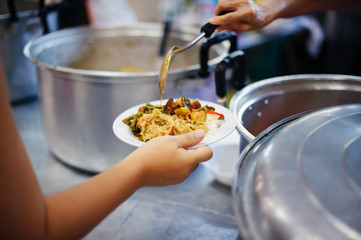 Hands of Refugees Receive Humorous Charity Food : The Concept of Food Shortage