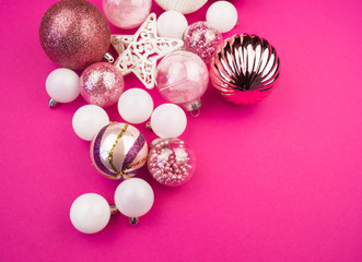 Gentle pink and white baubles on a pink background. Christmas mood. Copy space