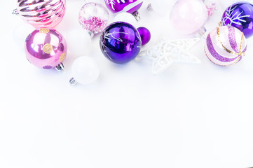 Gentle pink and purple baubles on a white background. Christmas mood. Copy space