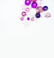 Gentle pink and purple baubles on a white background. Christmas mood. Copy space