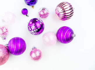 Gentle pink and purple baubles on a white background. Christmas mood. Copy space