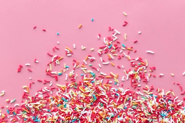 Colorful sprinkles on a pink background, top view with copy space © SEE D JAN
