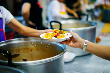 Homeless people pick up charity food from the food donors in society : concept homelessness