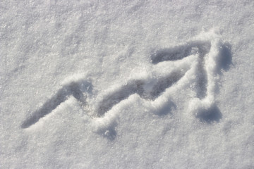 Up arrow drawn on the snow, the concept of rising prices in winter, cold weather.
