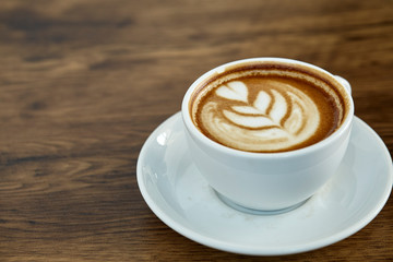 Cup of coffee with heart pattern