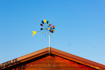 cottage shack with windmill on rooftop