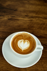 Cup of coffee with heart pattern