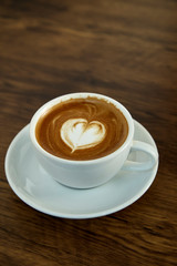Cup of coffee with heart pattern
