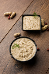 Healthy Peanut chutney made using Groundnut / Shengdana or mungfali. served in a small bowl with raw whole. Selective focus