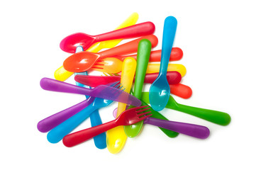 set of colorful baby plastic forks stacked on white background