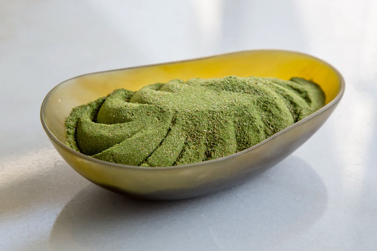 Top view of green powder in a bowl 