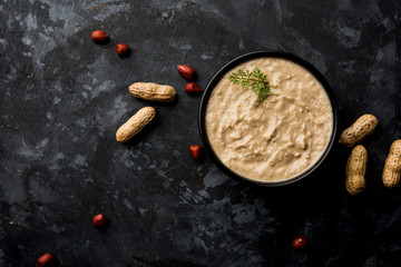 Healthy Peanut chutney made using Groundnut / Shengdana or mungfali. served in a small bowl with raw whole. Selective focus
