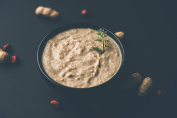 Healthy Peanut chutney made using Groundnut / Shengdana or mungfali. served in a small bowl with raw whole. Selective focus