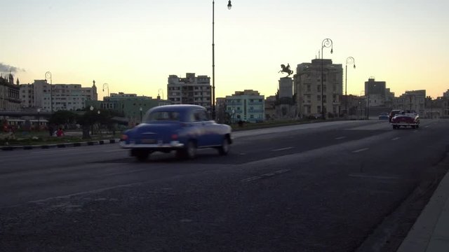 iconic classic 1950's American vintage convertible car driving on waterfront malecon street in old Havana, Cuba