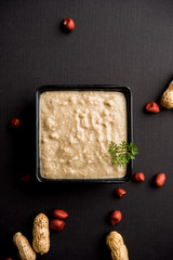 Healthy Peanut chutney made using Groundnut / Shengdana or mungfali. served in a small bowl with raw whole. Selective focus