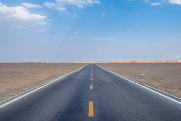 Car traveling on road in gobi desert in Dunhuang Yardang National Geopark, Gansu, China