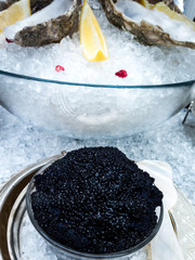 Caviar, sturgeon roe, served in a bowl surrounded by ice
