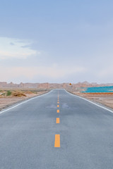Empty two-lane road in gobi desert in Dunhuang Yardang National Geopark, Gansu, China