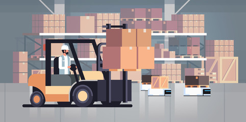 man driving forklift loader pallet truck warehouse robot car parcel box delivery logistic transport concept industrial goods storage room interior horizontal © mast3r