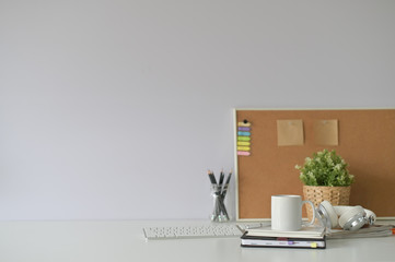 Copy space office desk with coffee mug, notebook and office supply with selective focus.