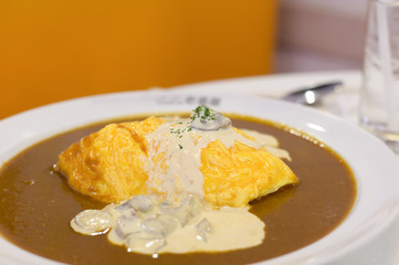 Curry and rice with mushrooms and omelet, Japanese food.
