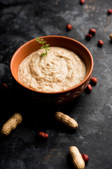 Healthy Peanut chutney made using Groundnut / Shengdana or mungfali. served in a small bowl with raw whole. Selective focus