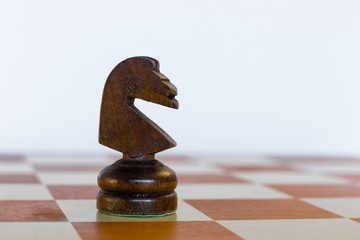 Black knight on white square on chessboard