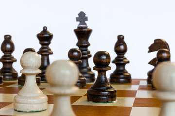Chess set on chessboard black and white pawns