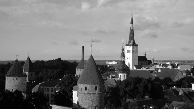 Tallinn, Estonia. Aerial view of Tallinn, Estonia during the sunny day. Cloudy blue sky with boats at the river. Time-lapse, black and white