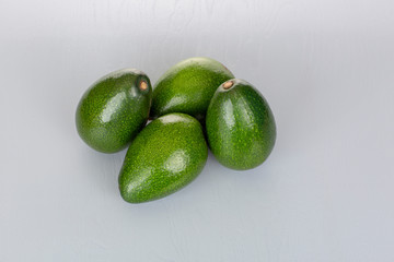 Fresh Green Avocados on White Backdrop Overhead