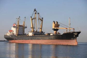 Dry cargo ship approaching the seaport berth