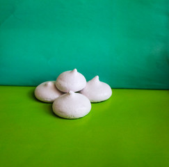 delicate airy meringue on green background.