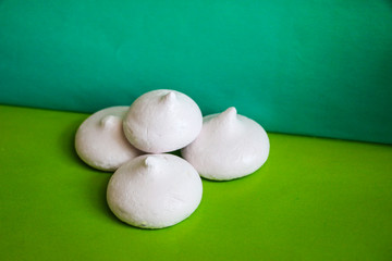 delicate airy meringue on green background.