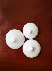 delicate airy meringue on brown background.