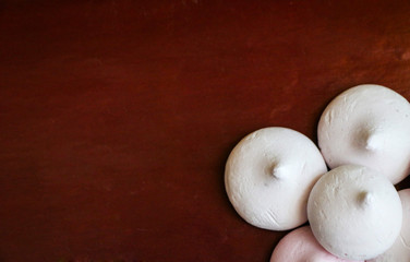 delicate airy meringue on brown background.