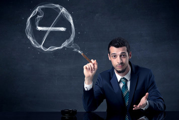 Businessman smoking cigarette and the smoke forms a no smoking sign.