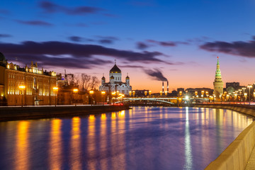 Beautiful sunset on Moskva river embankment with a view of Kremlin wall and Cathedral of Christ the Saviour in Moscow, Russia