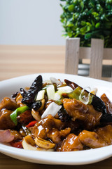 kung pao chicken is a spicy, stir-fried Chinese dish made with chicken, peanuts, vegetables, and dried chili peppers