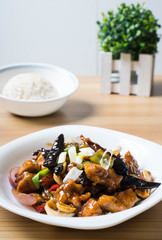 kung pao chicken is a spicy, stir-fried Chinese dish made with chicken, peanuts, vegetables, and dried chili peppers