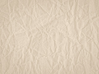 Texture of beige crumpled craft paper. Texture for design, abstract background